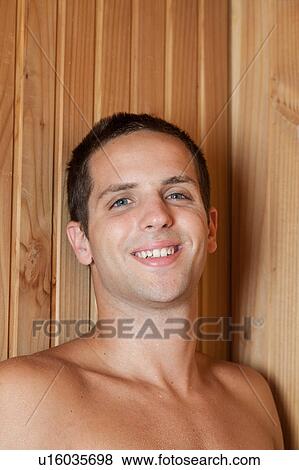 Stock Photo - Man smiling inside the sauna. Fotosearch