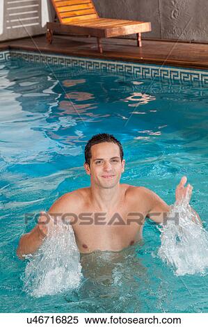 Man splashing water in the pool View Large Photo Image Stock Photography - Man splashing water in the pool. Fotosearch