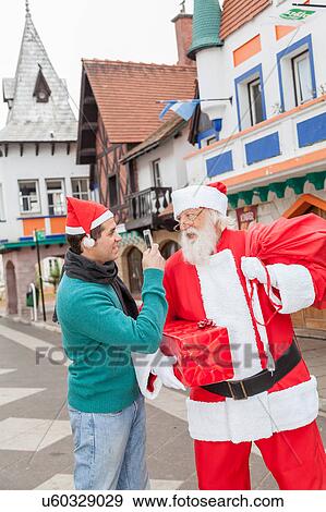 Man taking a photo to santa claus View Large Photo Image Stock Photo - Man taking a photo to santa claus. Fotosearch