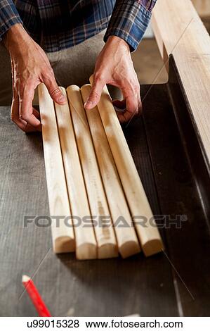 Stock Photo - Man taking a pieces of wood. Fotosearch