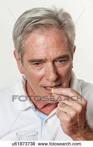 Man taking a pill View Large Photo Image Stock Photo - Man taking a pill. Fotosearch