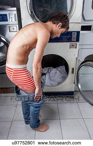 Man taking off his pants View Large Photo Image Stock Image - Man taking off his pants. Fotosearch