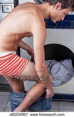Stock Photo - Man taking off his pants. Fotosearch