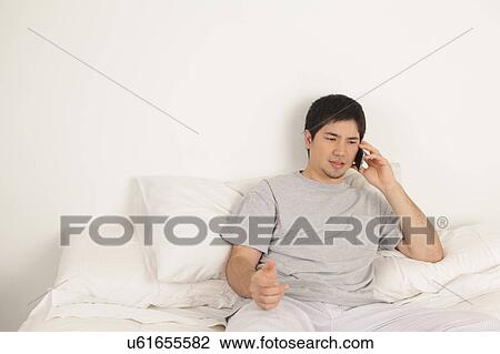 Stock Image - Man talking by phone. Fotosearch