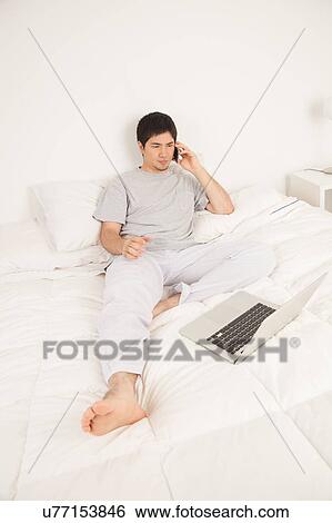 Stock Photograph - Man talking by phone. Fotosearch