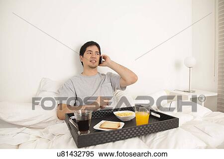 Man talking by phone while having breakfast View Large Photo Image Stock Photography - Man talking by phone while having breakfast. Fotosearch