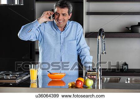 man talking phone in the kitchen View Large Photo Image Stock Photo - man talking phone in the kitchen. Fotosearch
