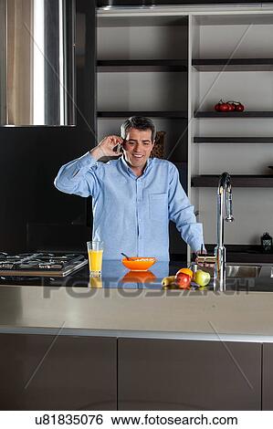 man talking phone in the kitchen View Large Photo Image Stock Photograph - man talking phone in the kitchen. Fotosearch