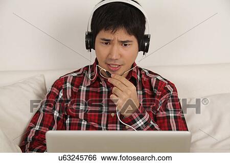 Stock Photograph - Man talking with headphones. Fotosearch