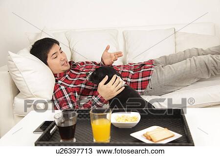 Stock Image - Man talking with the dog. Fotosearch