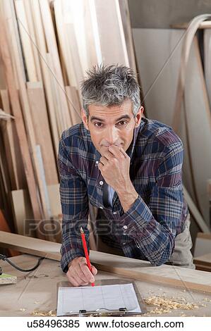 Man thinking in his workshop View Large Photo Image Stock Photography - Man thinking in his workshop. Fotosearch