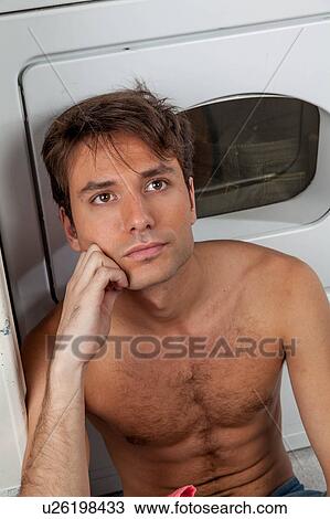 Stock Image - Man thinking in the laundry. Fotosearch