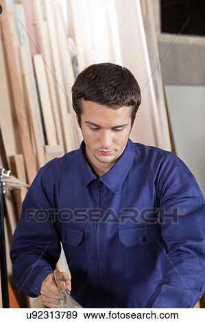 Stock Photo - Man using a saw. Fotosearch