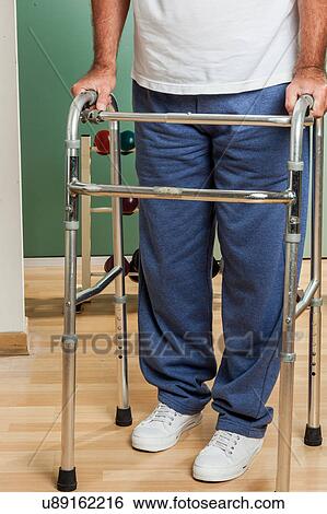 Man using a walker View Large Photo Image Stock Photograph - Man using a walker. Fotosearch