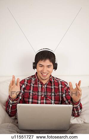 Man using the computer and celebrating View Large Photo Image Stock Photo - Man using the computer and celebrating. Fotosearch