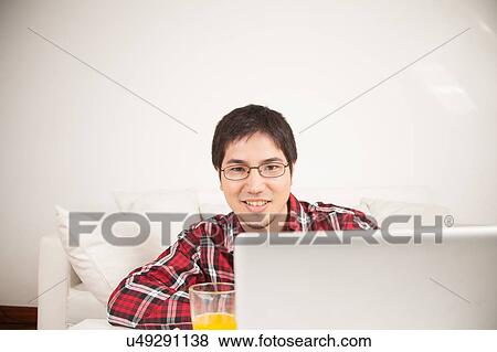 Man using the computer and looking at camera View Large Photo Image Stock Photo - Man using the computer and looking at camera. Fotosearch