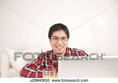 Man using the computer and looking at camera View Large Photo Image Stock Photography - Man using the computer and looking at camera. Fotosearch