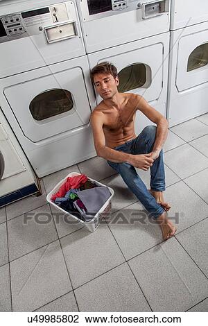Stock Image - Man waiting for clothes. Fotosearch