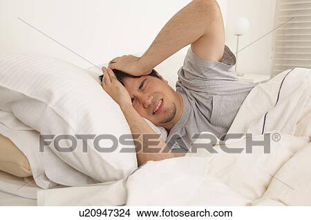 Man waking up with headache View Large Photo Image Picture - Man waking up with headache. Fotosearch