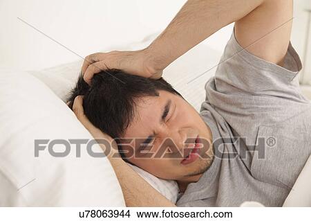 Man waking up with headache View Large Photo Image Picture - Man waking up with headache. Fotosearch