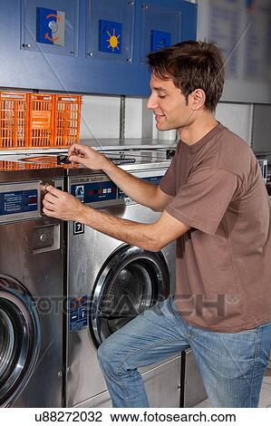 Stock Image - Man washing clothes. Fotosearch