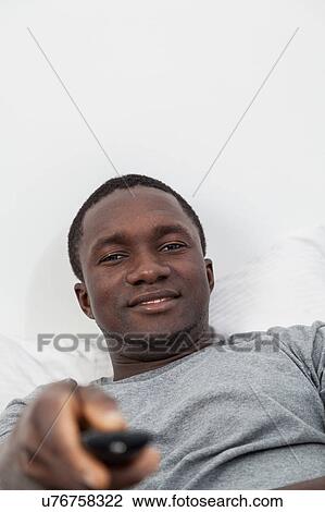Stock Image - Man watching tv. Fotosearch