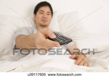Stock Photography - Man watching tv. Fotosearch