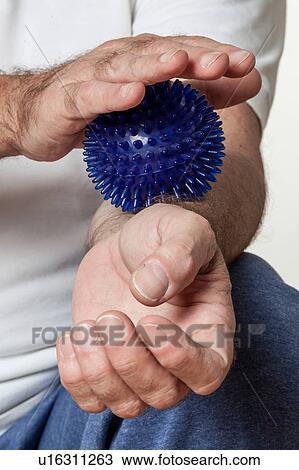 Stock Image - man who rehabilitates his hand. Fotosearch