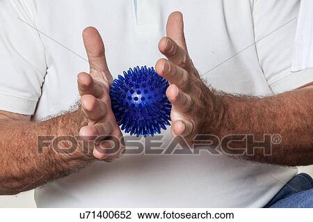 Stock Image - man who rehabilitates his hand. Fotosearch