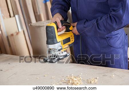 Man with a electric saw View Large Photo Image Stock Image - Man with a electric saw. Fotosearch