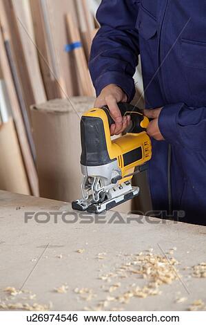 Man with a electric saw View Large Photo Image Stock Photograph - Man with a electric saw. Fotosearch