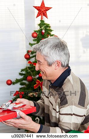 Stock Image - Man with a gift. Fotosearch