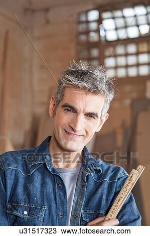 Stock Image - Man with a ruler. Fotosearch