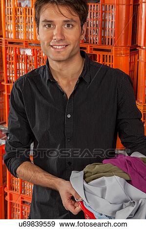 Man with baskets in the laundry View Large Photo Image Stock Photo - Man with baskets in the laundry. Fotosearch