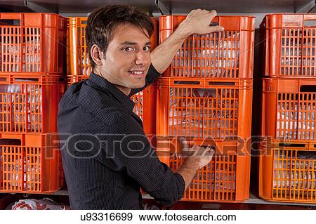 Stock Photo - Man with baskets in the laundry. Fotosearch