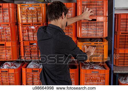 Man with baskets in the laundry View Large Photo Image Stock Photo - Man with baskets in the laundry. Fotosearch