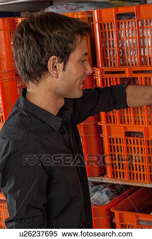 Man with baskets in the laundry View Large Photo Image Stock Photography - Man with baskets in the laundry. Fotosearch