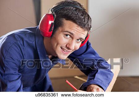 Stock Image - Man with protectors hearing. Fotosearch