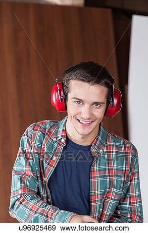 Stock Photo - Man with protectors hearing. Fotosearch
