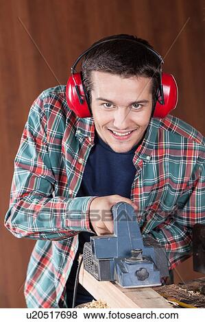 Stock Photo - Man working with a machine. Fotosearch