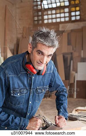 Man working with wood View Large Photo Image Picture - Man working with wood. Fotosearch