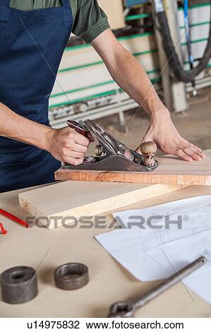 Man working with wood View Large Photo Image Stock Image - Man working with wood. Fotosearch