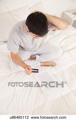 Stock Image - Man worried by contract. Fotosearch