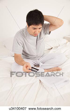 Stock Photo - Man worried by contract. Fotosearch
