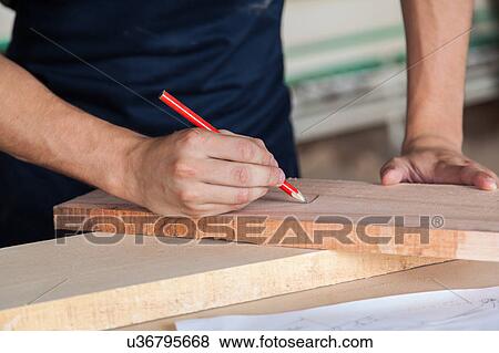 Stock Photo - Man writing in table of wood. Fotosearch