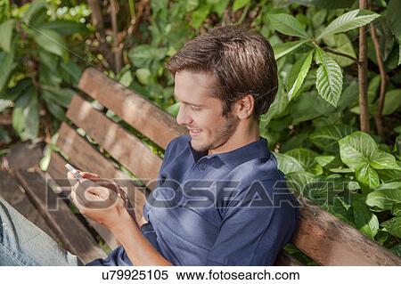 Stock Photography - Man writing in the park. Fotosearch