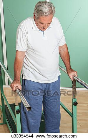 Mature man rehabilitating his legs View Large Photo Image Picture - Mature man rehabilitating his legs. Fotosearch