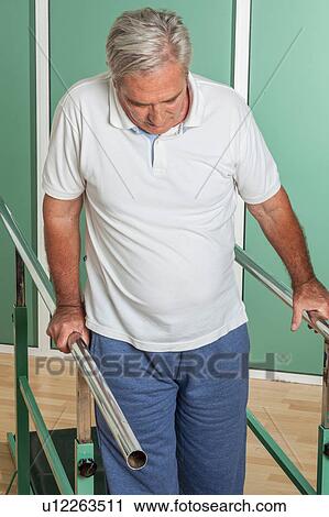Mature man rehabilitating his legs View Large Photo Image Stock Image - Mature man rehabilitating his legs. Fotosearch