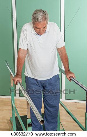 Mature man rehabilitating his legs View Large Photo Image Stock Image - Mature man rehabilitating his legs. Fotosearch