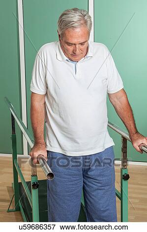 Mature man rehabilitating his legs View Large Photo Image Stock Photo - Mature man rehabilitating his legs. Fotosearch